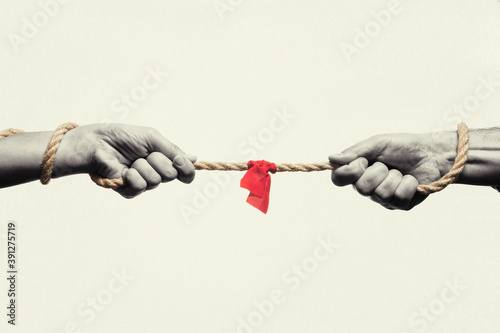 A man and a woman are tug of war. Concept. Black and white.