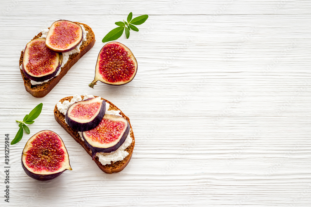 Toasted bread with figs, cheese and honey on table Toasted bread with figs, cheese and honey on table