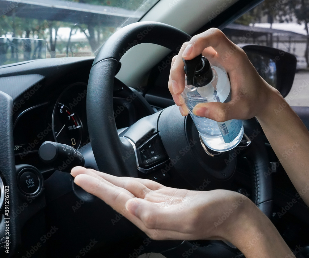 wash hand by alcohol gel sanitizer before driving car