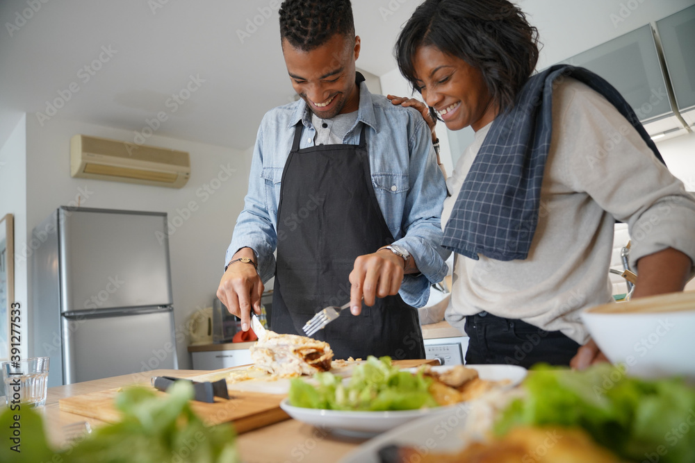 Portrait of african american couple having fun preparing meal together in home kitchen Portrait of african american couple having fun preparing meal together in home kitchen