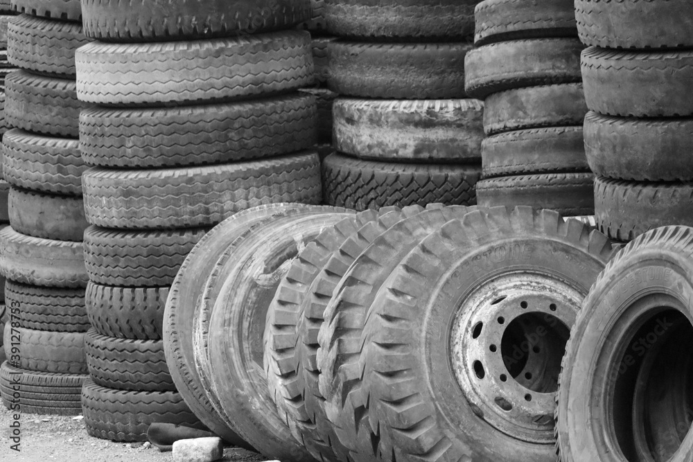 Bekasi / indonesia 25 September 2020. a pile of used car tires in black and white, suitable for wall paper, selective focus Bekasi / indonesia 25 September 2020. a pile of used car tires in black and white, suitable for wall paper, selective focus