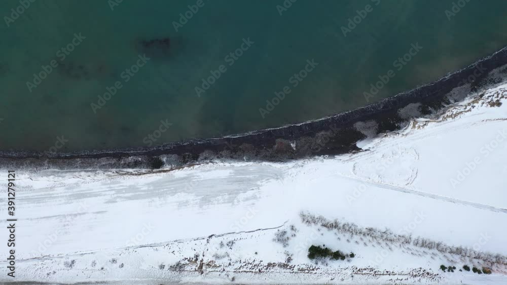 Turquoise Blue Ocean And Coast Covered With White Snow - Scenic View From Above In Iceland - top-down drone Turquoise Blue Ocean And Coast Covered With White Snow - Scenic View From Above In Iceland - top-down drone