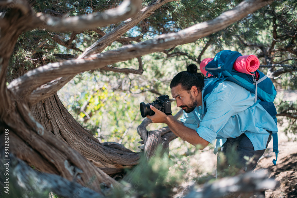Male photographer with a camera on a hike. Male photographer with a camera on a hike.