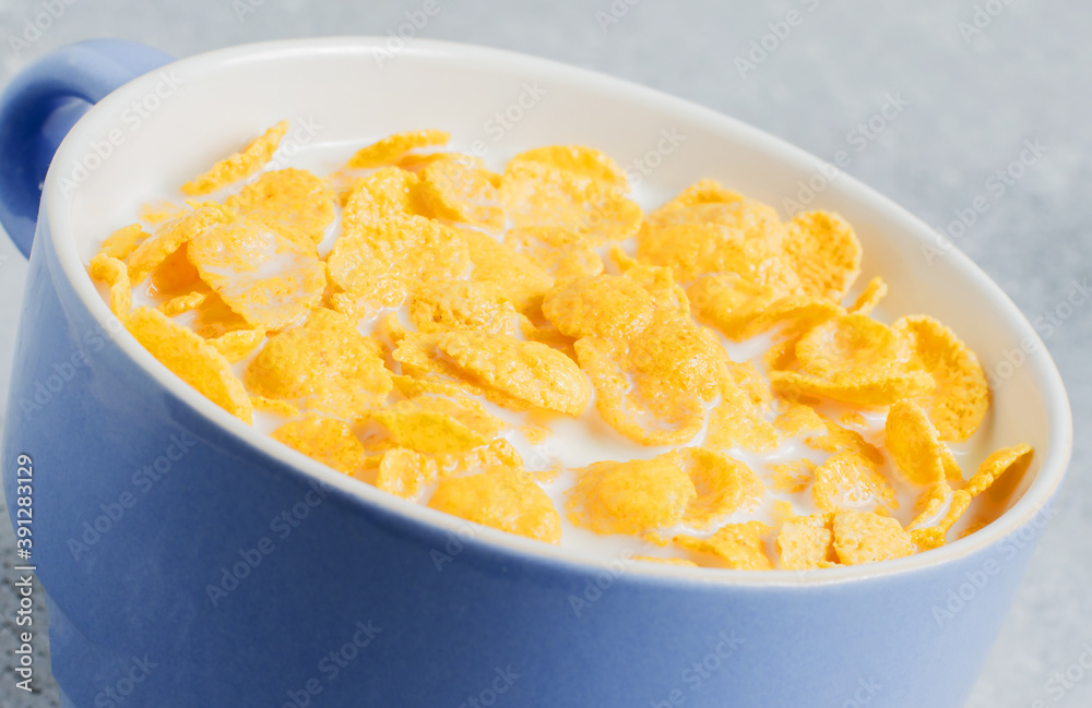 Corn flakes in milk. Blue Cup. Healthy and nutritious Breakfast. Copy space Corn flakes in milk. Blue Cup. Healthy and nutritious Breakfast. Copy space