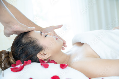 Young Asian woman doing spa massage in Thai spa shop.