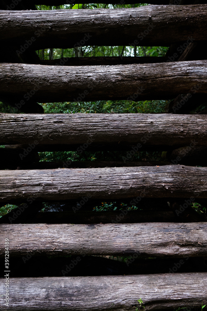 close up of vertical dark wooden logs close up of vertical dark wooden logs