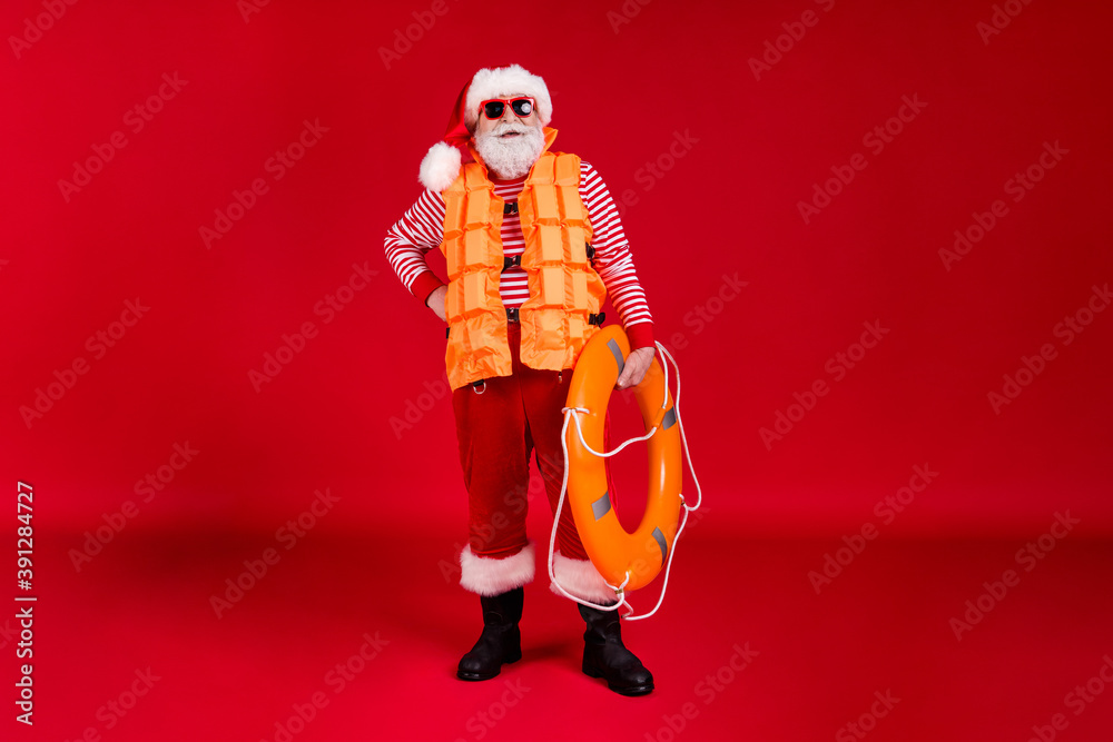 Full length body size view of his he nice handsome cheerful cheery confident bearded Santa father instructor wear sea safe vest carrying circle isolated bright vivid shine vibrant red color background