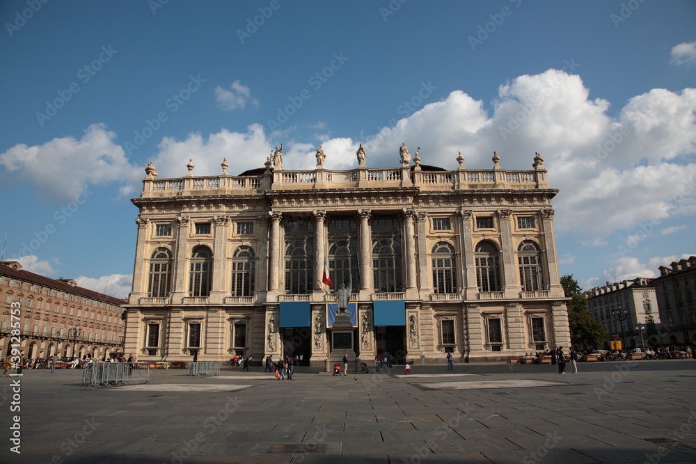 View of city square Piazza Castello and  Madama Palace under blue sky in Turin, Italy