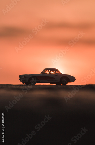car on the road in the sunset