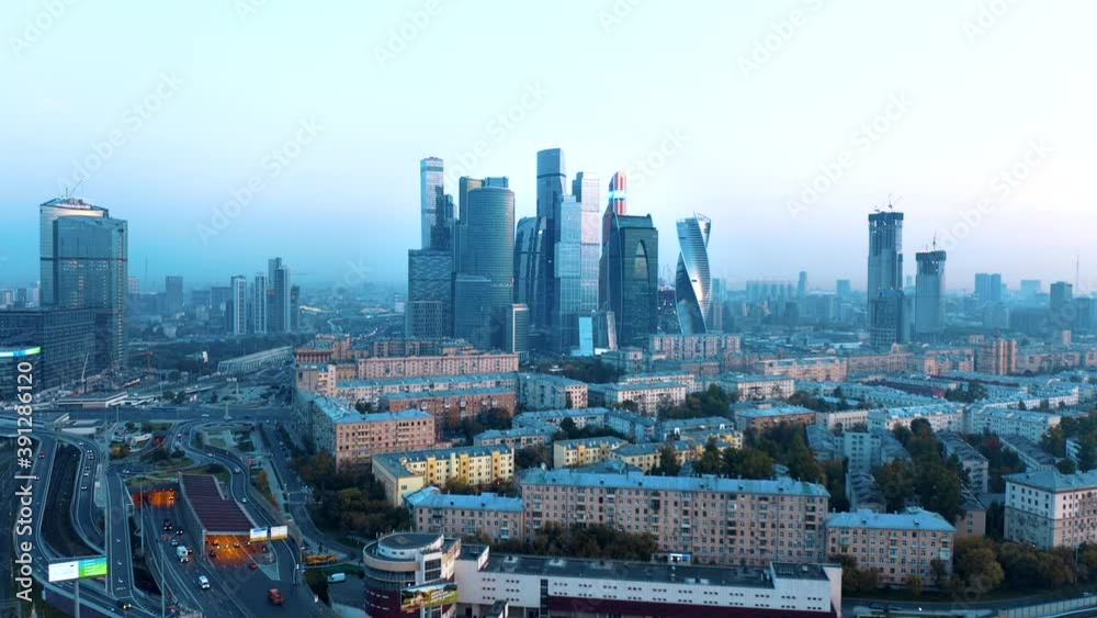 Moscow, Russia. Aerial above view of the high way with traffic jam and the Moscow city skyscrapers. Was filmed at evening 