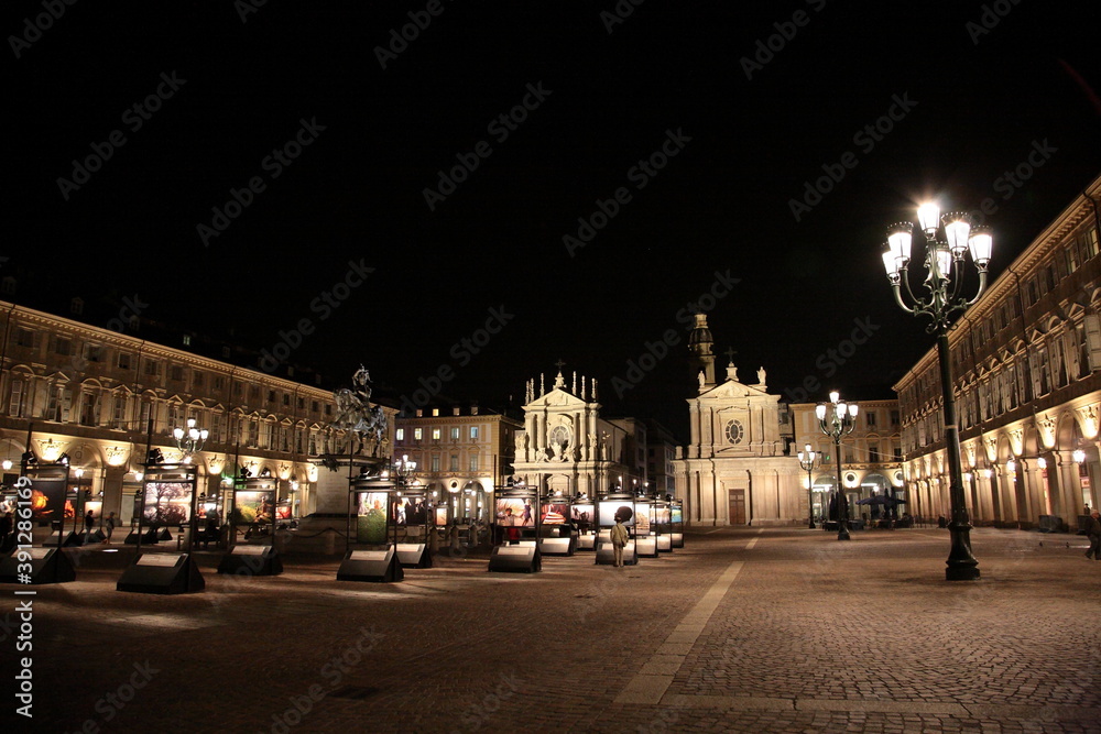 View of Baroque style Roman Catholic church San Carlo Borromeo and  Piazza San Carlo with Emanuele Filiberto Monument and art exhibition at night in Turin, Italy. 