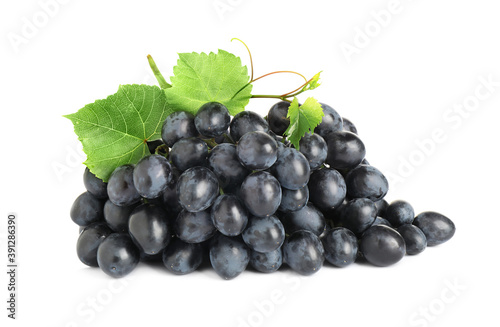 Bunch of fresh ripe juicy dark blue grapes with leaves isolated on white