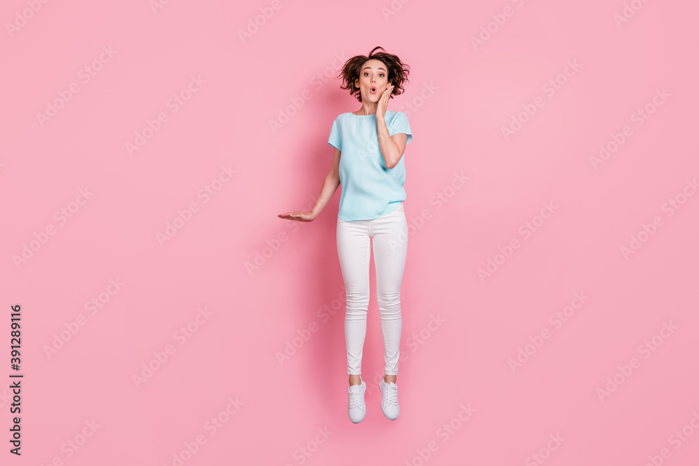 Full length photo of shocked surprised woman wear casual outfit jumping hand arm cheek isolated pink color background Full length photo of shocked surprised woman wear casual outfit jumping hand arm cheek isolated pink color background