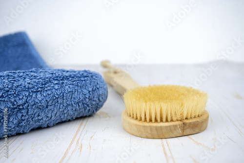 Skincare or body massage procedures concept. Set of wooden brush and towel to take a bath.