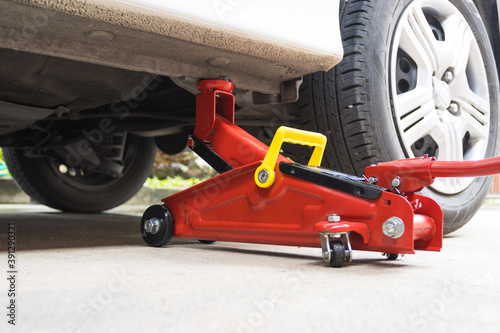 Car floor jack for car for repair check Maintenance of cars © piyaphunjun