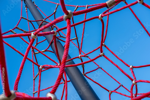 Red ropes on playground against the blue sky