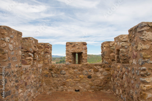 Battlements of a castle tower and the mountains in the background © davidmarin