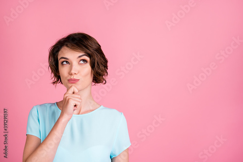 Photo of dreamy sweet woman wear casual blue t-shirt look empty space arm chin isolated pink color background