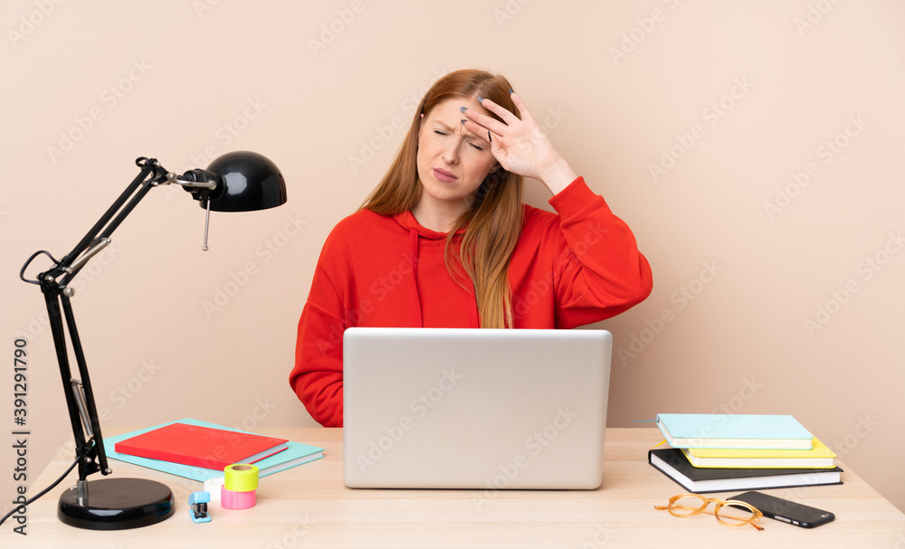 Young student woman in a workplace with a laptop with tired and sick expression Young student woman in a workplace with a laptop with tired and sick expression