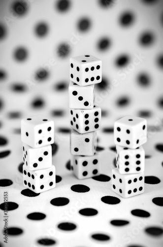 Dices camouflaged in a white background with black dots