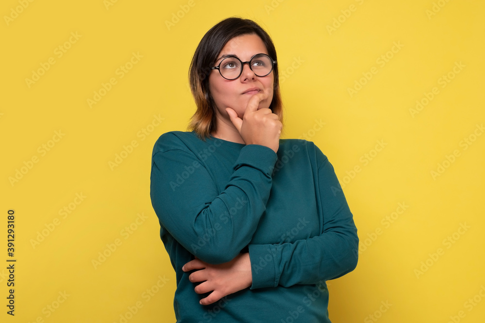 Caucasian woman with glasses having thoughtful look. Pensive female with puzzled expression thinking making a decisioan.