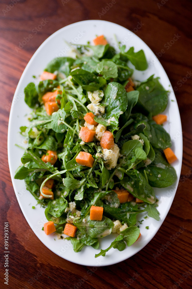 Close up of baby salad greens with sweet potato croutons