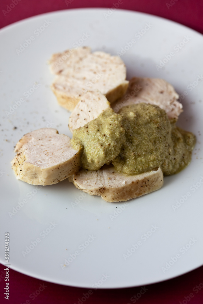 Chicken with green pipian served on white plate Chicken with green pipian served on white plate