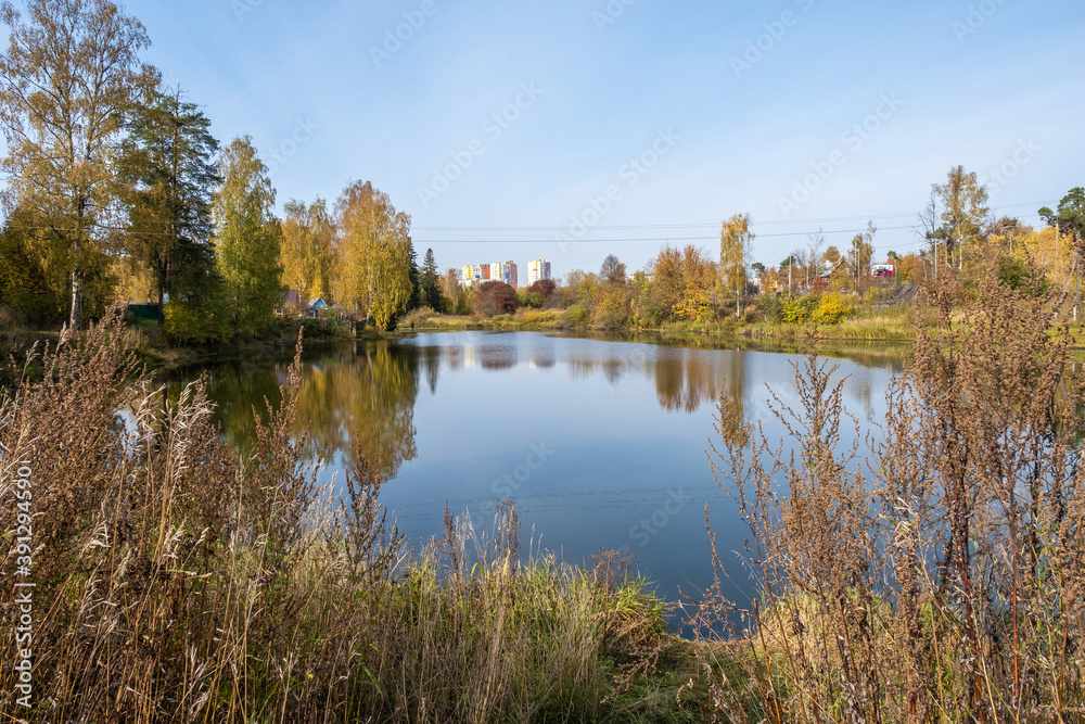 Autumn landscape with a small pond in the city of Kokhma, Ivanovo region.