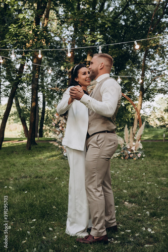 Newlyweds dance and have fun in nature. Walking the bride and groom outdoors. Beautiful summer photo session. © dimadasha