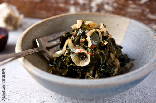 Braised collard greens in silver bowl