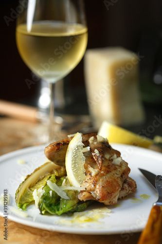 Chicken wing with endive and glass of white wine