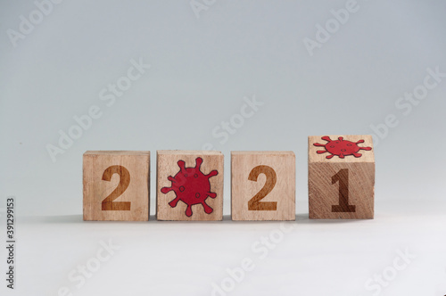 New year 2021, change from 2020 to 2021 concept, hand change wooden cubes. End of coronavirus pandemic photo