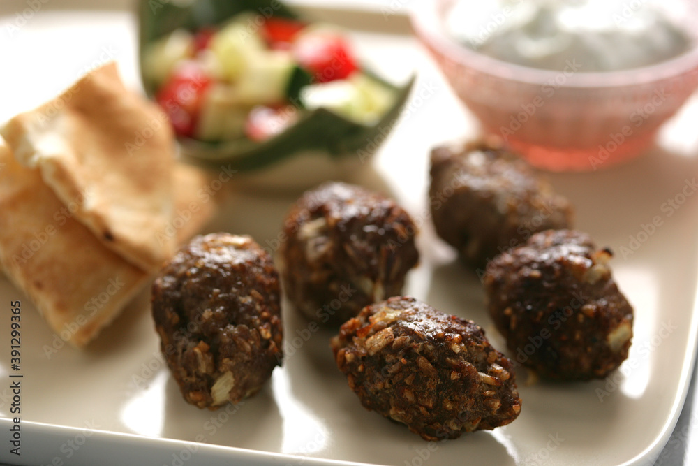 Close up of meatballs with dip on plate