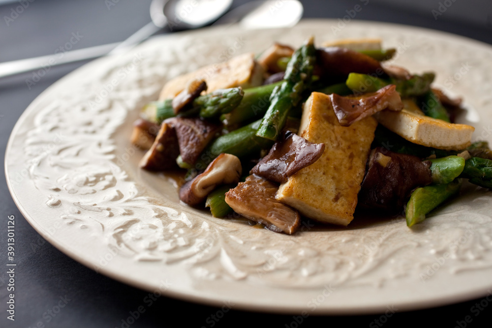 Close up of stir fry with mushrooms, tofu and asparagus Close up of stir fry with mushrooms, tofu and asparagus