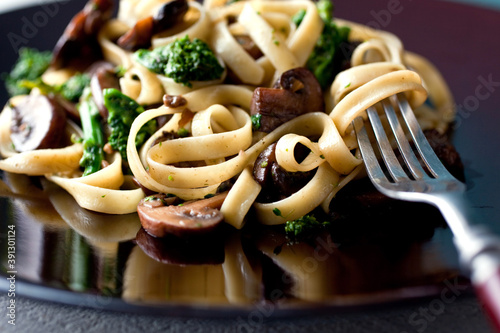 Close up of fettucine pasta with mushrooms and broccoli photo