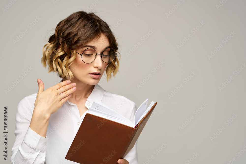 woman with notepad in hands business work beige background glasses hairstyle woman with notepad in hands business work beige background glasses hairstyle