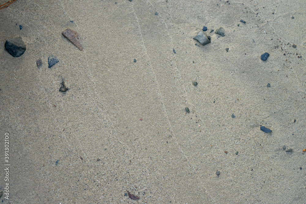 Sandy bottom of the reservoir close-up. Stones in the sand. Sandy bottom of the reservoir close-up. Stones in the sand.