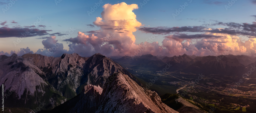 Beautiful Panoramic View of Canadian Rocky Mountain Landscape. Dramatic Colorful Sunset Sky Art Render. Taken from Mt Lady MacDonald, Canmore, Alberta, Canada.