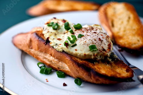 Eggs poached in buttery Sorrel sauce on toasted bread