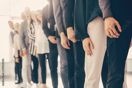 image of young business people standing in a long queue photo