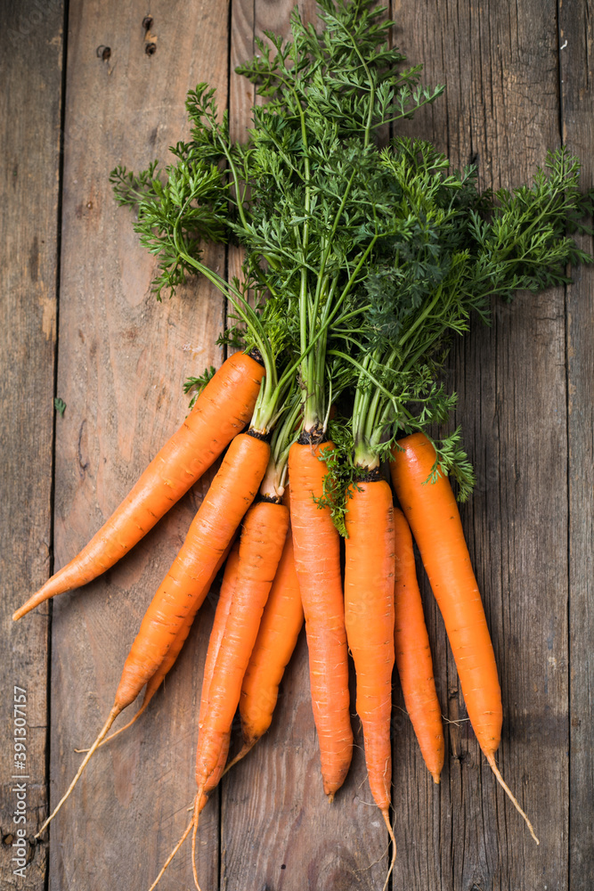 Fresh carrots bunch on rustic background. Healthy vegan vegetable food. Fresh carrots bunch on rustic background. Healthy vegan vegetable food.