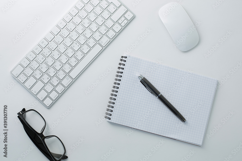Glasses keyboard mouse notepad and pen on white background Glasses keyboard mouse notepad and pen on white background