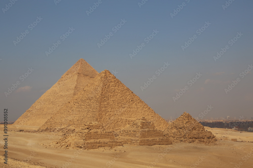 A picture of five of the great historical pyramids of Giza in the light of day, one of the Seven Wonders of the World, Giza - Egypt