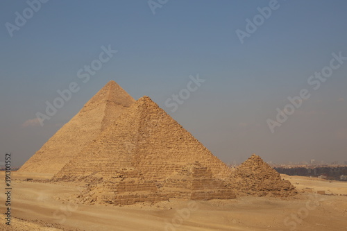 A picture of five of the great historical pyramids of Giza in the light of day, one of the Seven Wonders of the World, Giza - Egypt