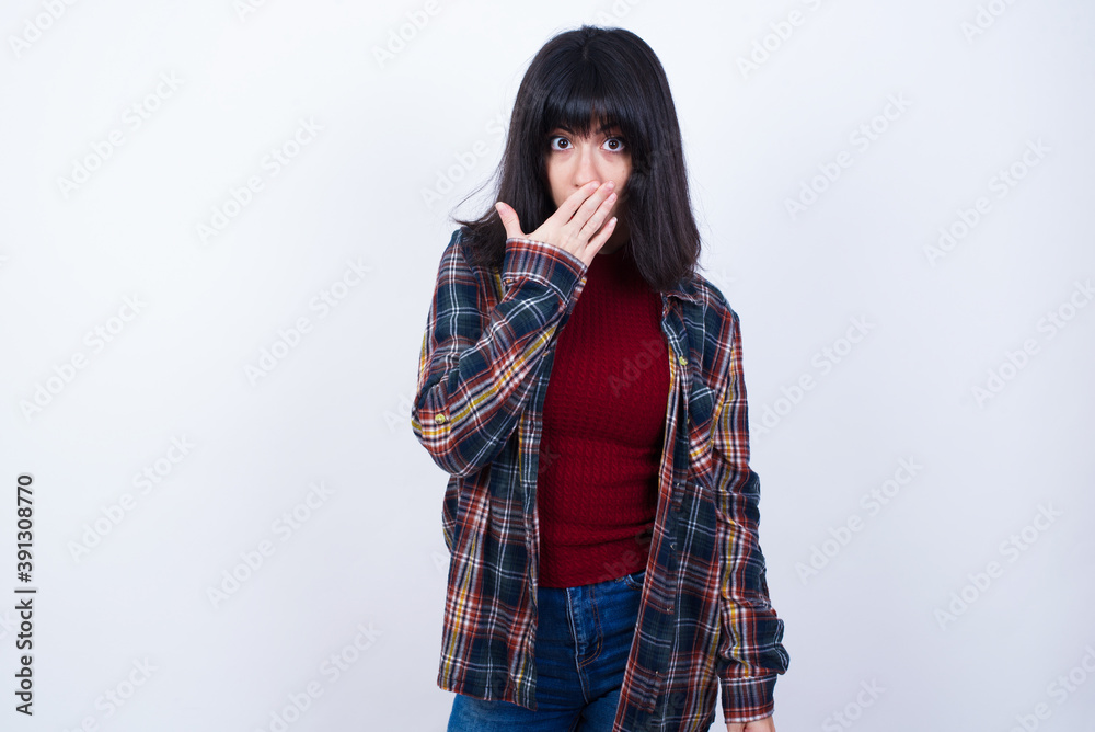 Oh! I think I said it! Close up portrait Beautiful young Caucasian woman standing against white background covers open mouth by hand palm, look at camera with big eyes. Oh! I think I said it! Close up portrait Beautiful young Caucasian woman standing against white background covers open mouth by hand palm, look at camera with big eyes.