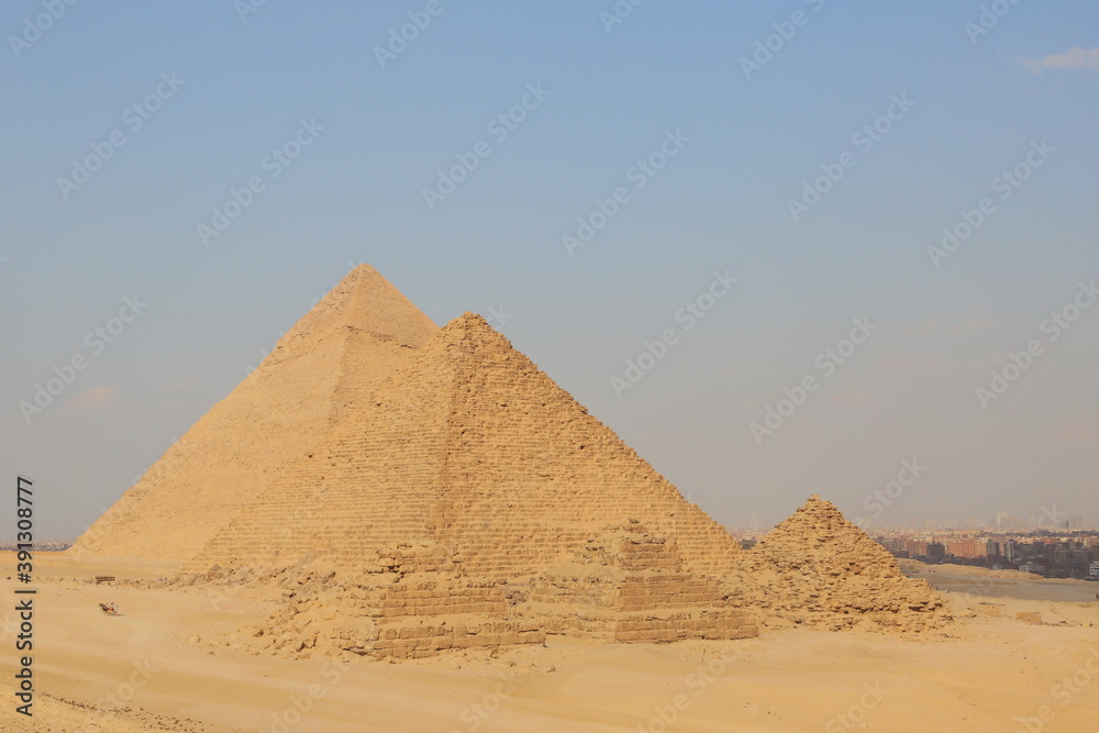 A picture of five of the great historical pyramids of Giza in the light of day, one of the Seven Wonders of the World, Giza - Egypt