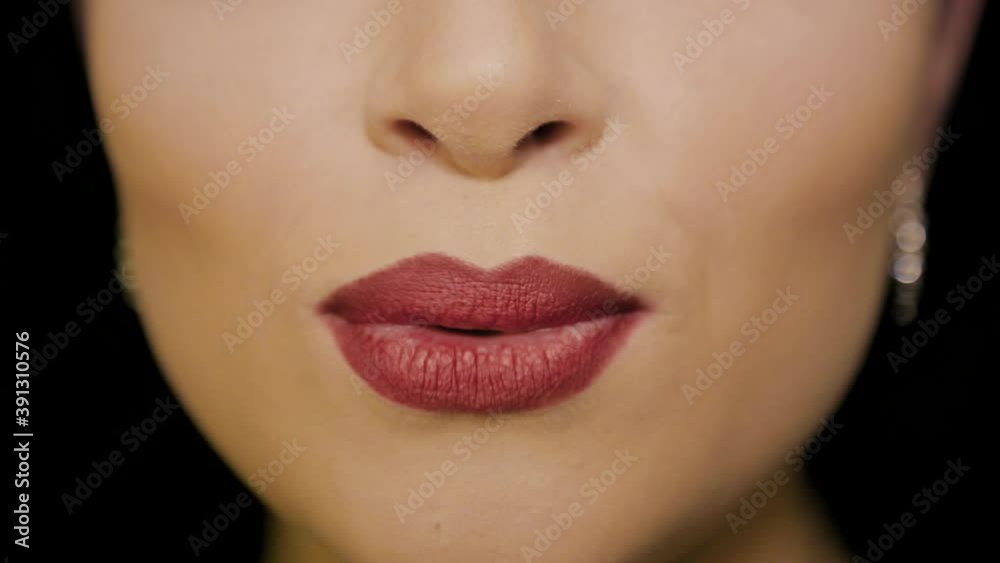 The girl speaks the words on the camera. The lips with red lipstick The girl speaks the words on the camera. The lips with red lipstick