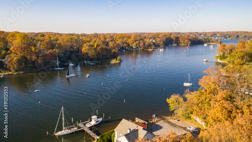 Aerial view of colorful sailboat moorings, docks,   and bright golden foliage on Weems Creek, in historic downtown Annapolis Maryland on a fall day