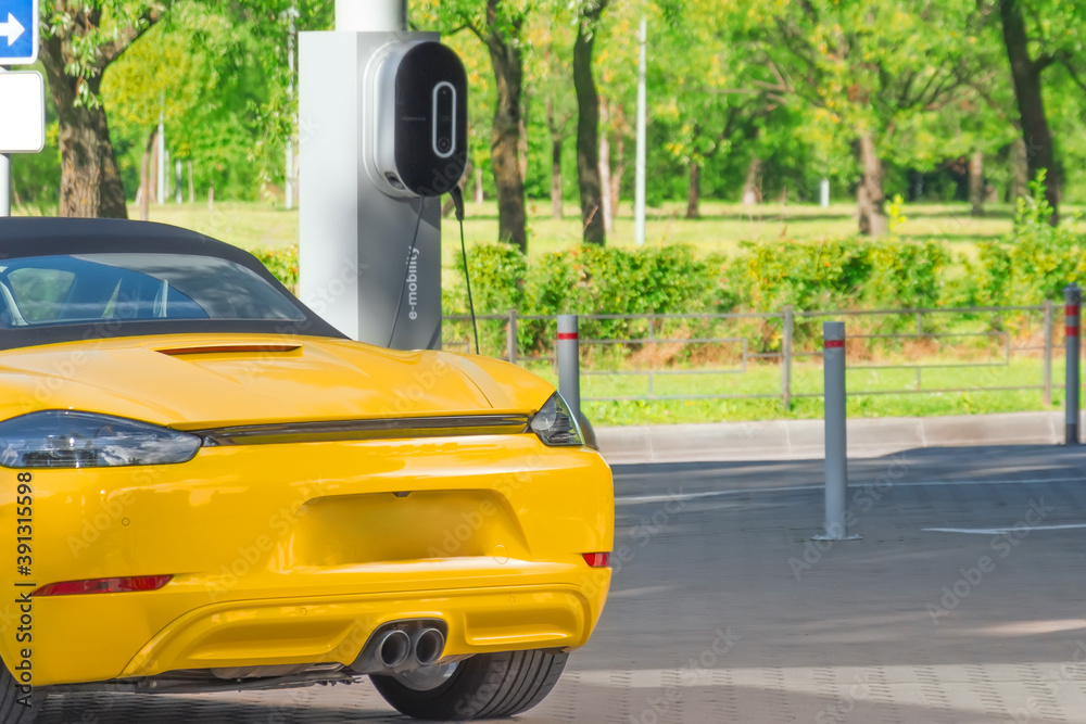 Electric car recharging parking lot, e-mobility. Hybrid engine gasoline and electricity repair shop service garage. Electric car recharging parking lot, e-mobility. Hybrid engine gasoline and electricity repair shop service garage.