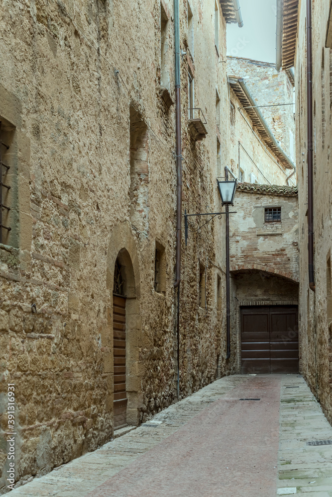old buildings on narrow lane at historical little town, Pienza, Siena, Italy
